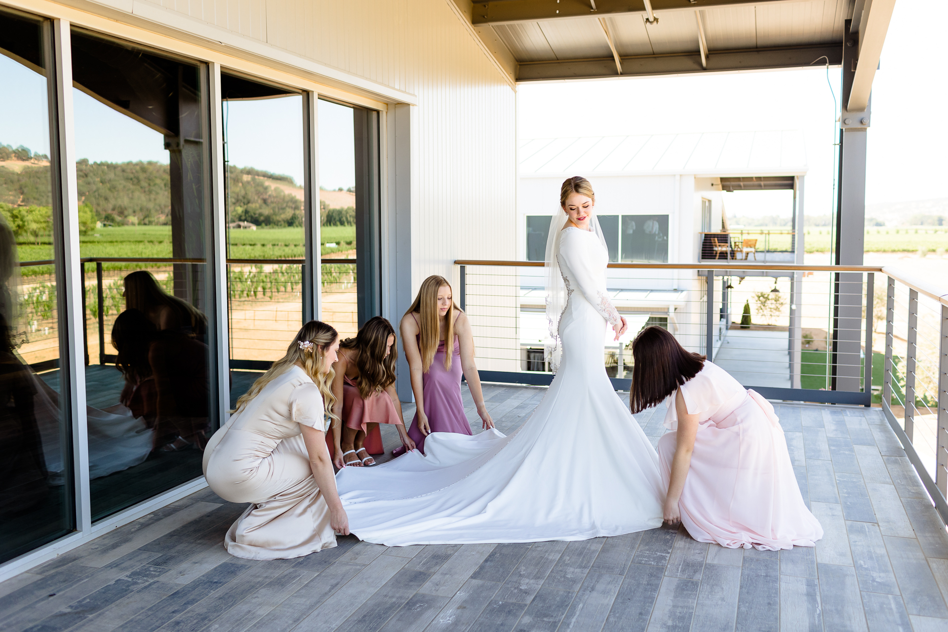 bridesmaids setting bride's dress