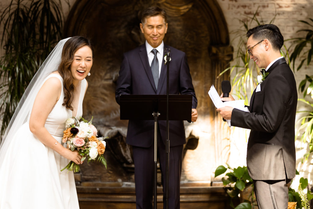 bride and groom laughing during their wedding ceremony