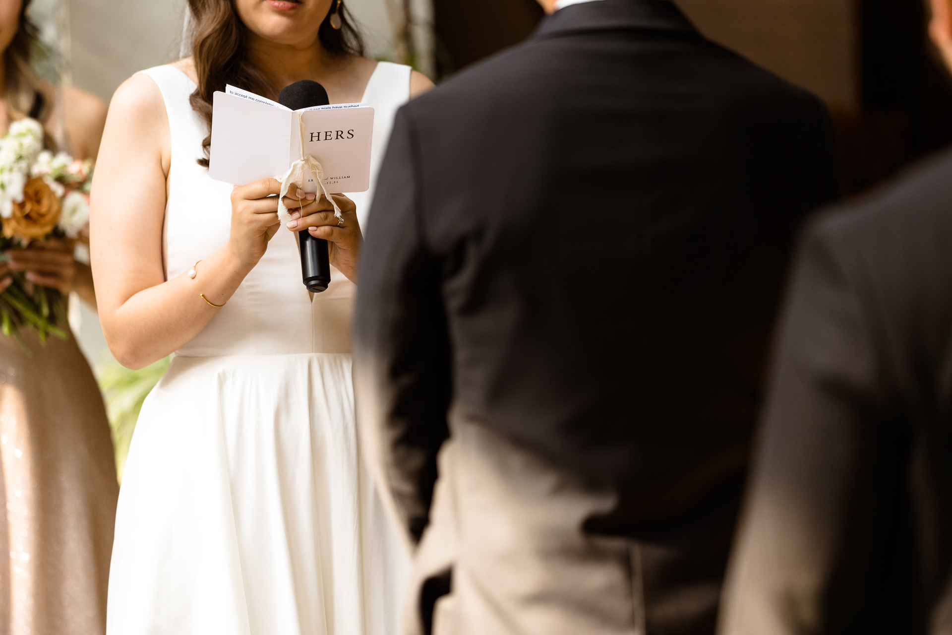 bride holding her vow book during her wedding ceremony