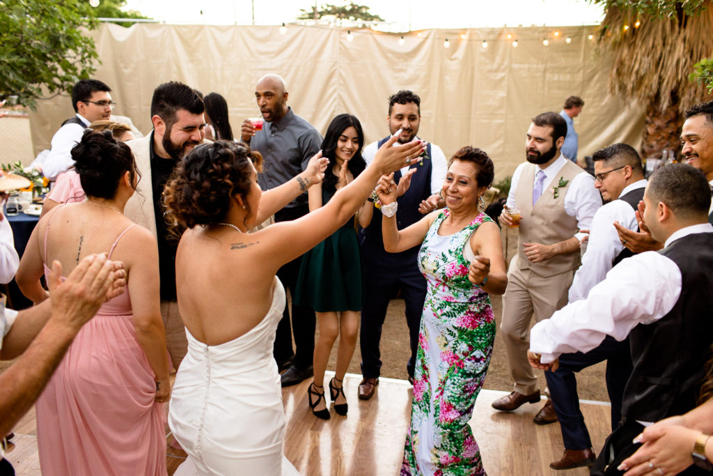 bride and mom dancing at backyard reception