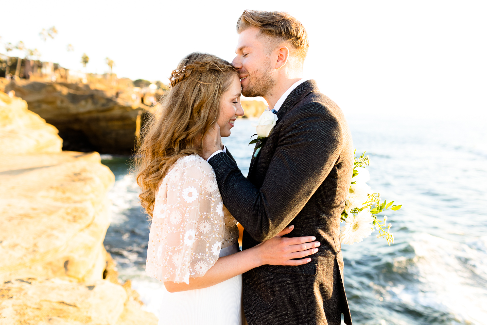 groom kissing bride's head - sunset cliffs, san diego