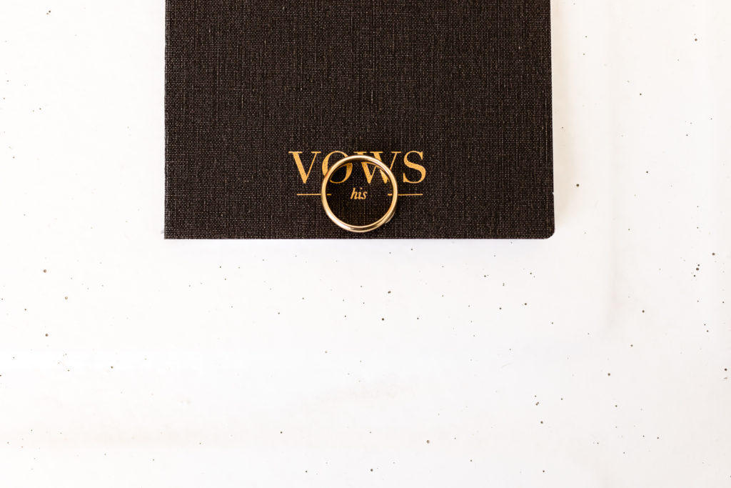 vow book with groom's ring